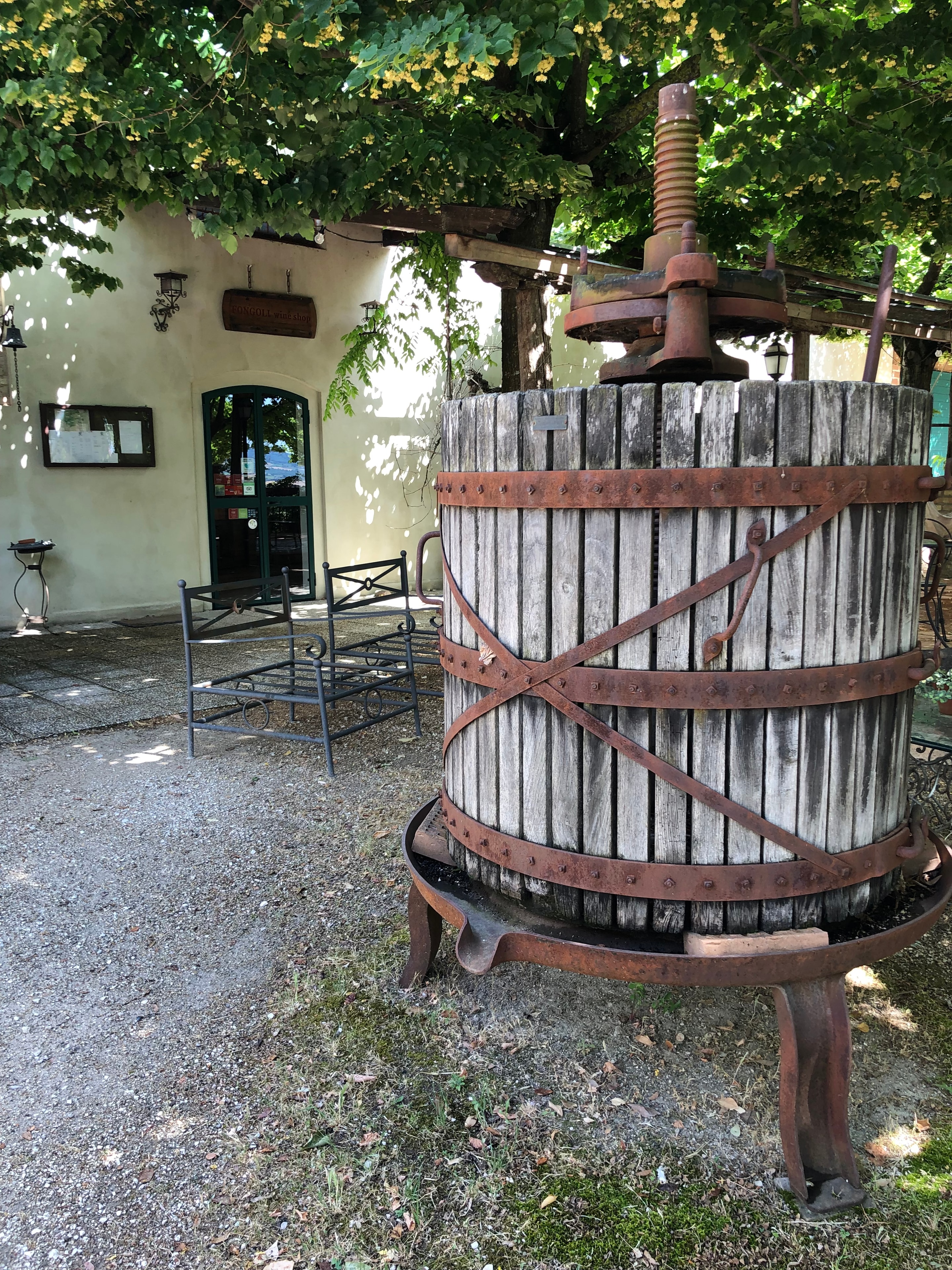 Antique wooden wine press with rusted iron bands
